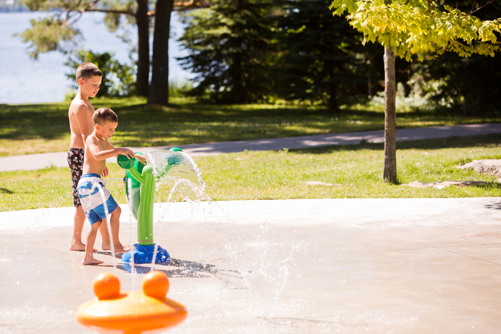 Children play at a splash pad.